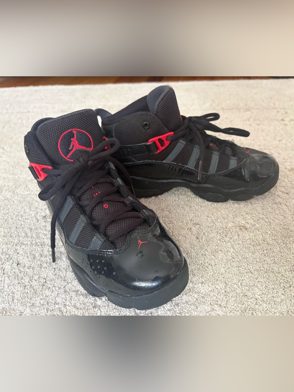 Kids Jordan Black Sneakers with Red Jumpman Accents